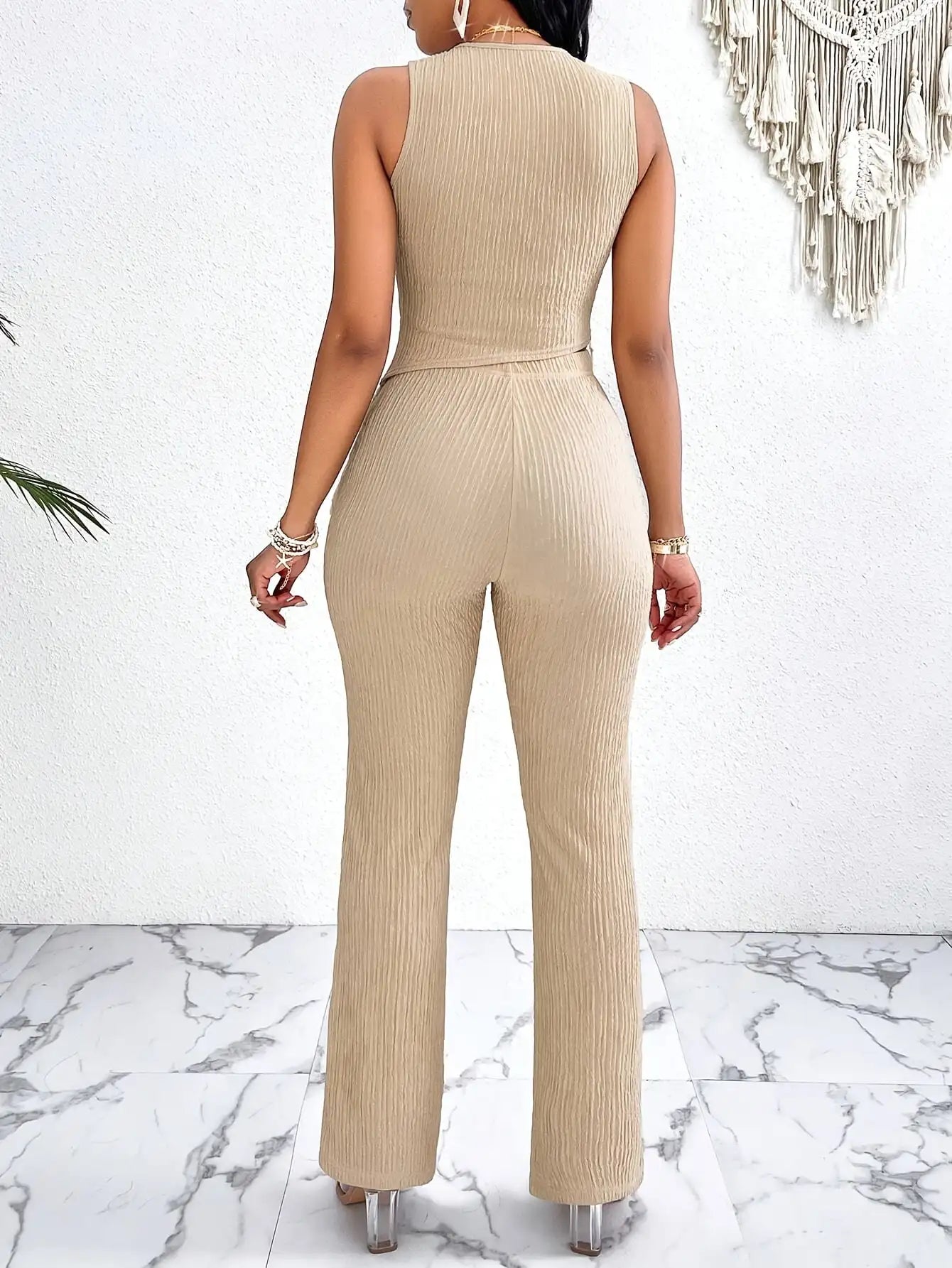 Textured suit pants set with fringed hem, asymmetrical vest, and straight-leg pants